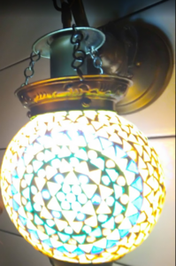 A round and external light source composed by small colorful triangles.